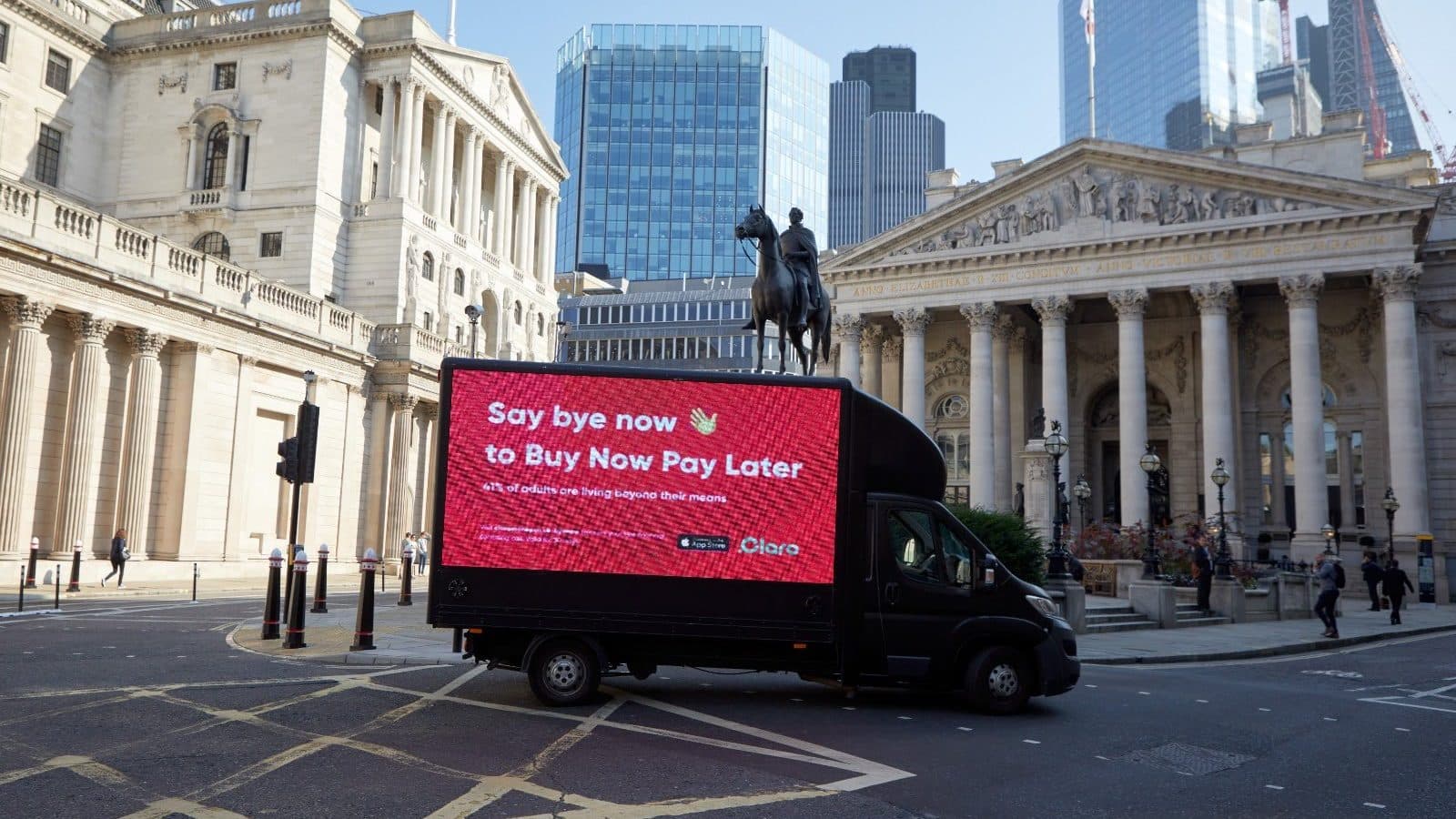 An advertising van carrying the Claro "Say bye now to Buy Now Pay Later" campaign, parked outside the Bank of England